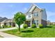 Charming two-story brick home with a well-manicured lawn and lovely landscaping at 10602 Pintail Ln, Indianapolis, IN 46239