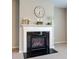 Close-up of the fireplace featuring white mantel, dark hearth, and decorative elements on top at 10602 Pintail Ln, Indianapolis, IN 46239