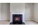 Close-up of the fireplace with black marble hearth and white painted mantle at 10602 Pintail Ln, Indianapolis, IN 46239