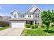 Charming two-story home featuring brick and siding, attached garage, and well-maintained landscaping at 10602 Pintail Ln, Indianapolis, IN 46239