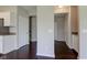 Hallway with hardwood floors connecting to kitchen, hallways and stairs at 10602 Pintail Ln, Indianapolis, IN 46239
