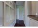 Well-lit hallway with built-in storage, a bench, and hardwood floors at 10602 Pintail Ln, Indianapolis, IN 46239