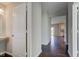 Hallway with hardwood floors leading to an open floor plan and view of the kitchen at 10602 Pintail Ln, Indianapolis, IN 46239