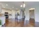 Open kitchen with stainless steel appliances, ample white cabinetry, and hardwood flooring at 10602 Pintail Ln, Indianapolis, IN 46239