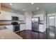 Eat-in kitchen with stainless steel appliances, white cabinets and hardwood flooring at 10602 Pintail Ln, Indianapolis, IN 46239