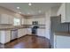Spacious kitchen with stainless steel appliances, white cabinets, and hardwood flooring at 10602 Pintail Ln, Indianapolis, IN 46239