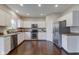 Functional kitchen with stainless steel appliances, white cabinets, and hardwood floors for a modern feel at 10602 Pintail Ln, Indianapolis, IN 46239