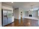 Open-concept living area featuring hardwood floors and a fireplace with white mantel at 10602 Pintail Ln, Indianapolis, IN 46239