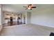 Open floor plan featuring a living room with plush carpeting leading into the kitchen at 10602 Pintail Ln, Indianapolis, IN 46239