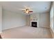 Comfortable living room boasting a fireplace, carpeted floors, and abundant natural light from the windows at 10602 Pintail Ln, Indianapolis, IN 46239