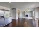Open concept living room with hardwood floors, fireplace, and stainless steel refrigerator at 10602 Pintail Ln, Indianapolis, IN 46239