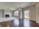 Open-concept living area with fireplace, hardwood floors, and sliding glass doors to the backyard at 10602 Pintail Ln, Indianapolis, IN 46239
