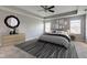Stylish main bedroom with tray ceiling, ceiling fan, and decorative mirror and bedding at 10602 Pintail Ln, Indianapolis, IN 46239