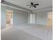 Spacious main bedroom with neutral walls, carpet, and tray ceiling with fan at 10602 Pintail Ln, Indianapolis, IN 46239
