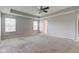 Spacious main bedroom featuring neutral tones, a ceiling fan, and natural light from two windows at 10602 Pintail Ln, Indianapolis, IN 46239