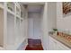 Mudroom features built-in storage, coat hooks, and a granite countertop at 10602 Pintail Ln, Indianapolis, IN 46239