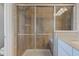 Close-up of shower with glass enclosure, tiled walls, built-in seat, and modern showerhead at 10602 Pintail Ln, Indianapolis, IN 46239