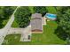 Aerial view of a home with a long driveway, lush green lawn, and swimming pool at 11054 N Shelby 490 W, New Palestine, IN 46163