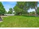 Spacious lawn with a swimming pool in the distance offers plenty of space to play or entertain at 11054 N Shelby 490 W, New Palestine, IN 46163