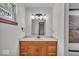 Bathroom vanity with marble countertop, decorative lighting, and wood cabinetry at 11054 N Shelby 490 W, New Palestine, IN 46163