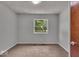 This bedroom features neutral walls, plush carpeting, and natural light at 11054 N Shelby 490 W, New Palestine, IN 46163