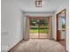 A carpeted dining room with a sliding glass door and view of the backyard at 11054 N Shelby 490 W, New Palestine, IN 46163