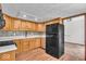 A view of the kitchen features natural wood cabinets and stainless steel appliances at 11054 N Shelby 490 W, New Palestine, IN 46163