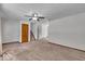 Open living room featuring neutral carpet, ceiling fan, and stairway at 11054 N Shelby 490 W, New Palestine, IN 46163