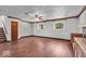 Open living room features hardwood floors, natural light, and a ceiling fan at 11054 N Shelby 490 W, New Palestine, IN 46163