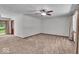 An open living room features a large picture window, ceiling fan, and doorway to the dining room at 11054 N Shelby 490 W, New Palestine, IN 46163