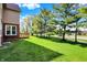 Lush green backyard with a charming deck, mature trees, and sunny exposure at 11599 Braemar Ct, Carmel, IN 46032