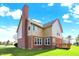 Well-maintained backyard view showcasing the home's exterior, deck, and lawn on a sunny day at 11599 Braemar Ct, Carmel, IN 46032