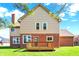 Two-story home with a wooden deck overlooking a spacious backyard on a sunny day at 11599 Braemar Ct, Carmel, IN 46032
