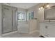 Bathroom with tub, shower, and white vanity, complemented by natural light from the window at 11599 Braemar Ct, Carmel, IN 46032