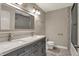 Bathroom featuring a double sink vanity with modern fixtures, and a tiled shower at 11599 Braemar Ct, Carmel, IN 46032