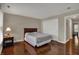 Bedroom features hardwood floors, a bed, and an end table by a bright window at 11599 Braemar Ct, Carmel, IN 46032