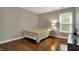 Cozy bedroom features hardwood floors, neutral paint, and a large window for ample natural light at 11599 Braemar Ct, Carmel, IN 46032