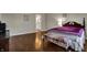 Bright bedroom with hardwood floors, connecting to a bathroom, and a comfortable bed at 11599 Braemar Ct, Carmel, IN 46032