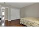 Bedroom with hardwood floors, a double closet, and view into hallway at 11599 Braemar Ct, Carmel, IN 46032
