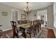Dining room featuring a chandelier, large table with chairs, and hardwood floors at 11599 Braemar Ct, Carmel, IN 46032