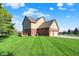 Well-maintained home featuring brick accents, attached two-car garage, and a spacious lawn at 11599 Braemar Ct, Carmel, IN 46032