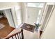 Open foyer with a decorative rug, light tile floors, and staircase with wood railing from above at 11599 Braemar Ct, Carmel, IN 46032