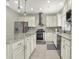Bright kitchen features white cabinetry, stainless steel appliances, and granite countertops at 11599 Braemar Ct, Carmel, IN 46032