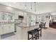 Bright, eat-in kitchen featuring white cabinets, granite countertops, an island, and stainless-steel appliances at 11599 Braemar Ct, Carmel, IN 46032