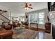 Cozy living room with hardwood floors, fireplace, and open layout to kitchen at 11599 Braemar Ct, Carmel, IN 46032