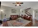 Open living room with hardwood floors, staircase, leather furniture, and an ornate rug at 11599 Braemar Ct, Carmel, IN 46032