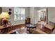 Comfortable sitting room with hardwood floors, natural light, and a view to entry at 11599 Braemar Ct, Carmel, IN 46032