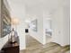Bright hallway with wood floors, decorative art, and a glimpse into a tastefully decorated bedroom at 11832 Vale St, Indianapolis, IN 46235