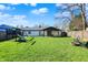 Spacious fenced backyard featuring a well-maintained lawn, playset, and covered patio, perfect for outdoor activities at 1280 Casco Bay Cir, Cicero, IN 46034