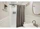 Bright bathroom featuring a shower with gray curtain, sink, and stylish decor at 1280 Casco Bay Cir, Cicero, IN 46034